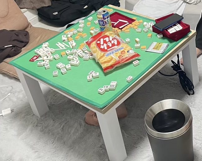 ローテーブルにマットを敷いて麻雀をしている様子
